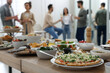 © New Africa - Brunch table setting with different delicious food.and blurred view of people on background