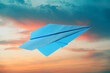 © New Africa - Light blue paper plane and view of beautiful sky at sunset