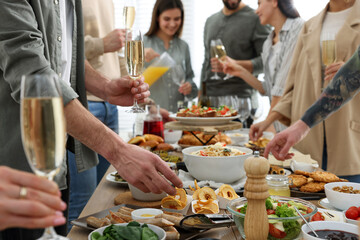 Canvas Print - People near buffet table with food indoors, closeup. Brunch setting