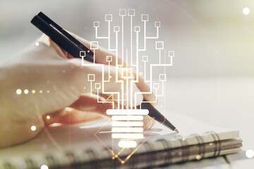 Poster - Creative idea concept with light bulb and microcircuit illustration and woman hand writing in notebook on background. Neural networks and machine learning concept. Multiexposure