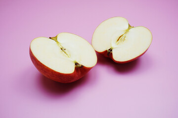 Poster - Apple cut half slices on pink background