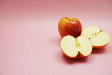 Canvas Print - Apple cut half slices with space copy on pink background