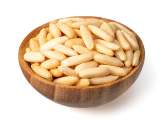 Wall Mural - Roasted pine nuts in the wooden bowl. isolated on white background.