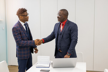 handshake of two african men in suits