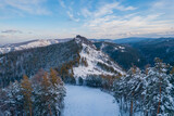 Fototapeta Kawa jest smaczna - Aerial top view city Krasnoyarsk Russia taiga forest and rocks of stolby sanctuary, winter sunset