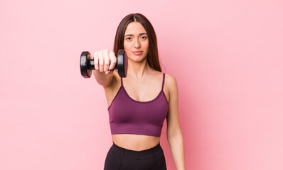 Poster - young adult pretty woman with a dumbbell. fitness concept