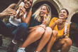 © Davide Angelini - Laughing teenage girls eating ice cream cones on city street - Young female friends enjoying icecream outside - Summer lifestyle concept