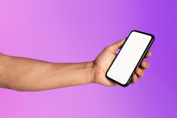 Poster - Cropped view of millennial man holding cellphone with empty white screen in neon light, mockup for mobile app or website