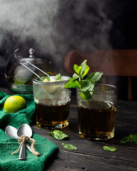 Poster - Vertical shot of a couple of beverage glasses decorated with mint leaves and smoke