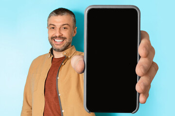 Poster - Middle Aged Man Showing Huge Phone Empty Screen, Blue Background