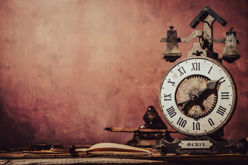 Vintage wallpaper with copy space. Antique desk with clock, inkwell and pen.