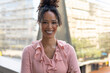 © Wavebreak Media - Portrait of smiling african american mid adult businesswoman with arms crossed standing in balcony