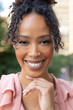 © Wavebreak Media - Close-up portrait of smiling african american mid adult businesswoman with hand on chin