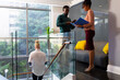 © Wavebreak Media - African american mid adult business professionals discussing over document while standing in office