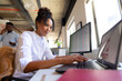 © Wavebreak Media - African american mid adult businesswoman using laptop while working at desk in office