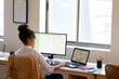 © Wavebreak Media - African american mid adult businesswoman using laptop and desktop computer while working in office