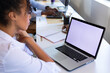 © Wavebreak Media - African american mid adult businesswoman looking at laptop with copy space while working in office