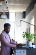 © Wavebreak Media - African american mid adult businessman using laptop while standing at table in office