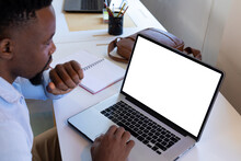 African American Mid Adult Businessman Using Laptop With Blank Screen While Working In Office