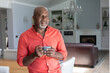 © WavebreakMediaMicro - Thoughtful african american senior man looking away while having coffee at home