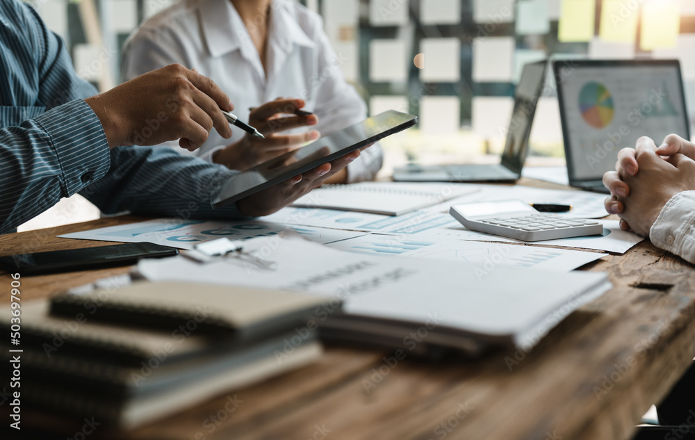 Asian business adviser meeting to analyze and discuss the situation on the financial report in the meeting room.Investment Consultant, Financial advisor and accounting concept