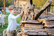 © Iryna - School age teenager blond boy, petting little goat in the kids farm. Cute kind child feeding animals. Agritourism concept.