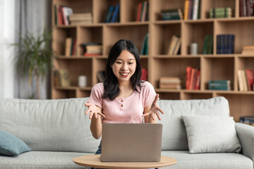 Poster - Online video call. Excited asian lady having virtual conference via laptop computer, talking and gesturing to webcam