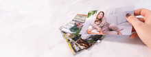 Woman Sitting At Desk And Looking At Printed Photos, Remember Nostalgia For A Day Of Rest. Photography Cards, Background. Mock Up