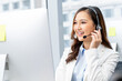 © Atstock Productions - Cheerful Asian woman worker wearing headset with microphone talking to client while working in mordern call center office