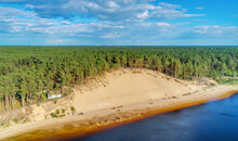 Aerial View Of White Dune Near The Lielupe River Covered With Pine Forest With A Blue Sky In Latvia