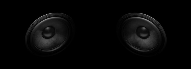 A pair of modern powerful sound speakers on a dark background.