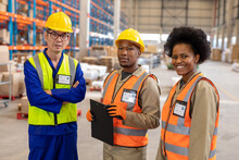 Portrait Of Asian Mature Male Foreman Standing With African American Young Male And Female Coworkers