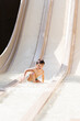 © ADDICTIVE STOCK - Cute child riding slide in water park on sunny summer day