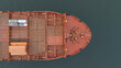 Aerial straight down view of the bow of an empty cargo ship at sea.