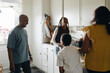 © Maskot - Cheerful family having fun in kitchen at home