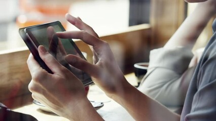 Aufkleber - Hand of a woman scrolling online on a digital tablet. Businesswoman using a wireless tablet in a cafe. Woman scrolling on her digital tablet pinching and zooming in.