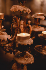 Sticker - Glowing candle on an old vintage retro candelabrum covered with wax