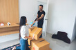 © PIPAT - An Asian and Caucasian couple are packing boxes to move house, where they live happily using tape to seal the boxes in preparation for moving.