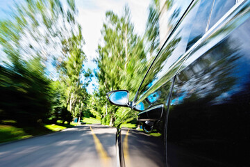 Poster - Car in motion blur driving in the forest