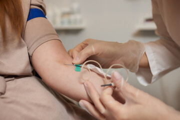 Young woman in blood transfusion concept hand.