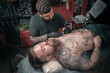 © Mr. Prof - Professional tattooer and his customer in the workshop