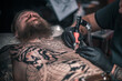 © Mr. Prof - Tattooer makes cool tattoo in the salon