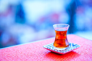 Traditional Turkish tea. Bardak - a glass in the shape of a tulip. Excellent delicious breakfast on the coast. Unforgettable view in Turkey. Strong sweet tea is a landmark of Turkey and Istanbul