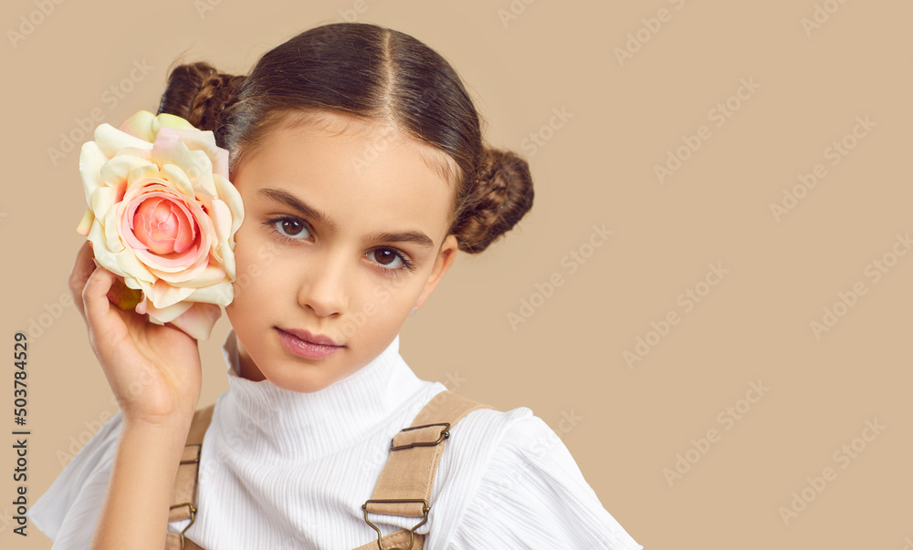 nude child girl model Closeup fashion shot of beautiful teen girl isolated on nude brown studio  background pose with rose. Pretty teenager child model with flower.  Children photography. Copy space, advertising. の Stock フォト | Adobe