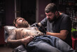 © Mr. Prof - Tattooist makes tattoo pictures in tattoo studio