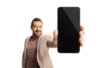 Wall Mural - Smiling man showing a blank screen of a smartphone in front of camera