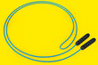 Blue skipping rope or jumping rope isolated on yellow background.