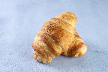 Wall Mural - Gourmet cheese and sesame croissant, displayed on gray background