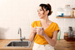 © Cavan Images - Young woman enjoying coffee at home