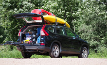 SUV Vehicle Packed Up And Ready For An Outdoor Whitewater Kayaking Vacation Trip